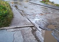 Разбитая дорога во вдоре домов по Гоголя, 2, Дзержинского 11, Дзержинского 11а